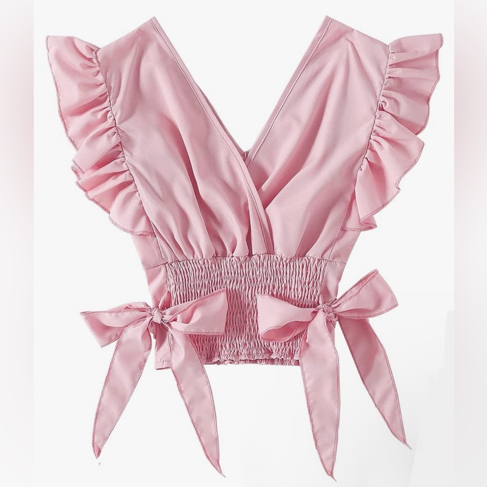 Light pink, low V-neck blouse with bows on the side and ruffles at sleeves.